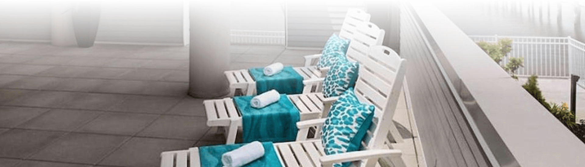 Three deck chairs on dock in blue and white