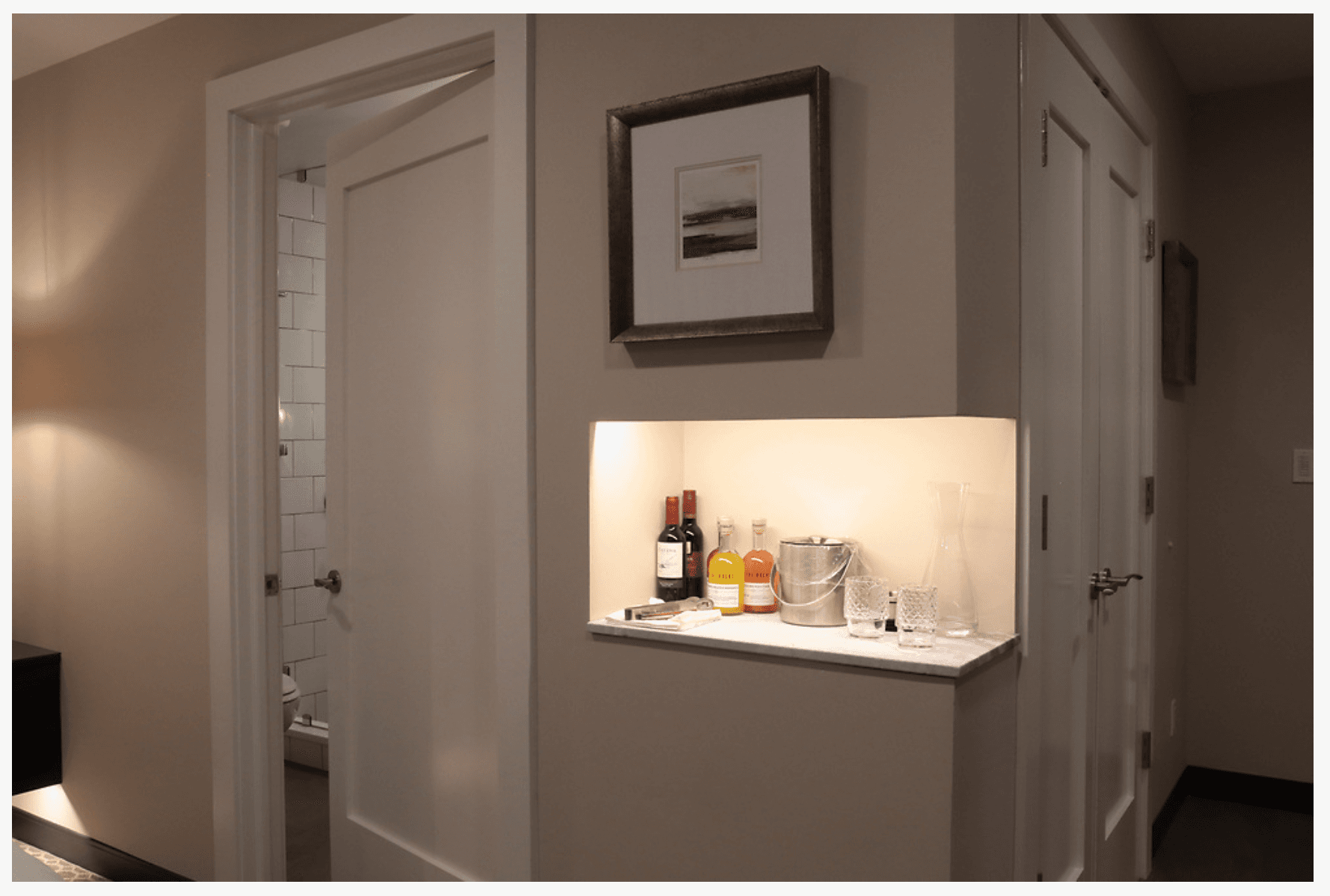 on a built-in marble shelf with soft lighting over it.